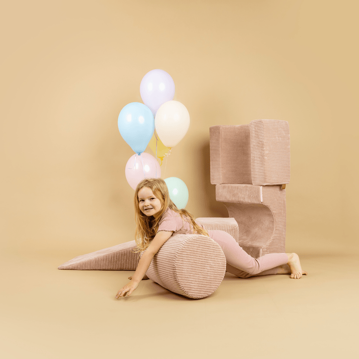 Child sitting among the 4-Element MeowBaby Aesthetic Shape Set pieces with balloons