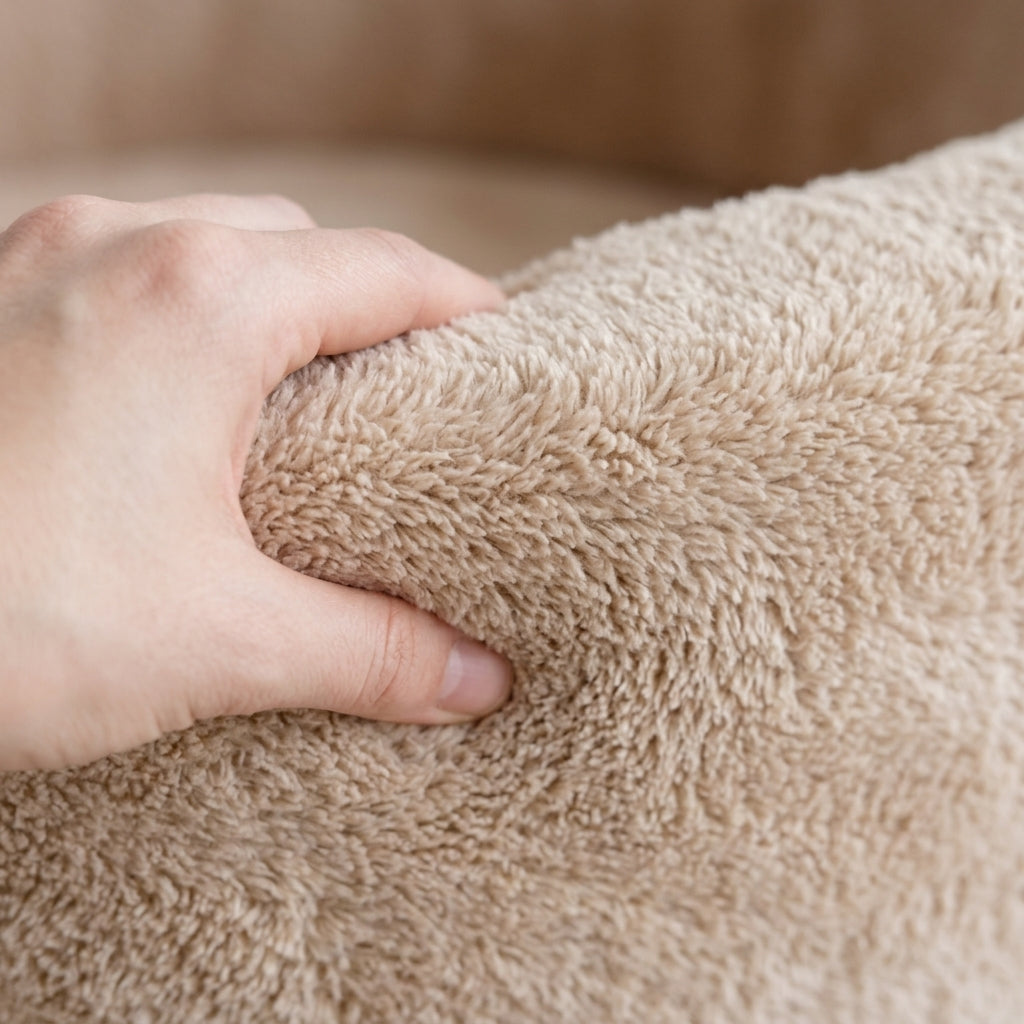Close-up of the soft plush fabric texture on the Monio for Kids Beige Plush Round Ball Pit