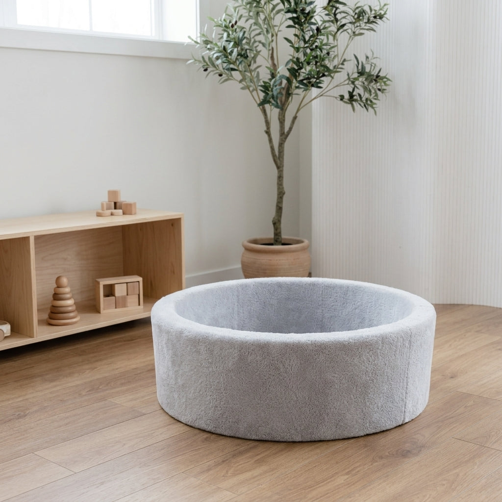 Monio for Kids Light Grey Plush Round Ball Pit styled in a bright Scandinavian nursery corner