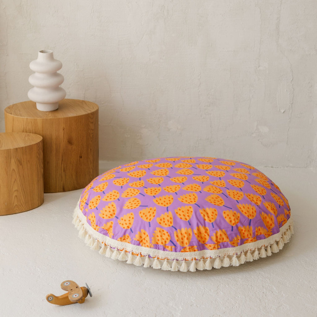 MINICAMP round floor cushion in tulip pattern shown from an angle