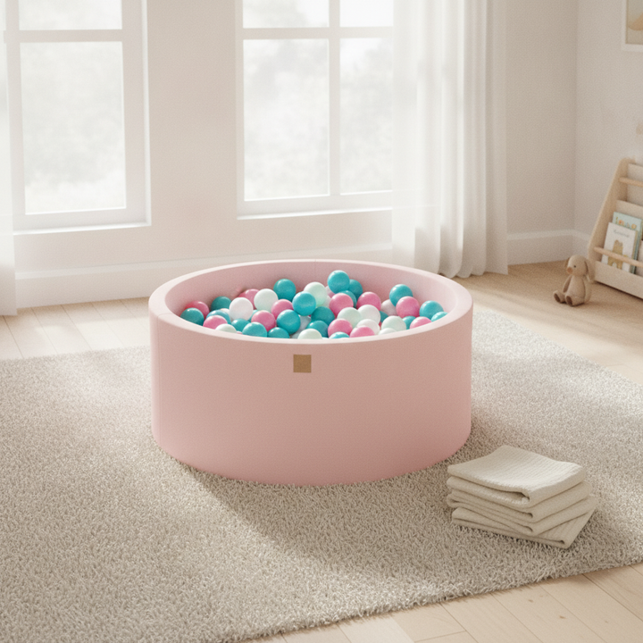 MeowBaby Powder Pink Round Cotton Ball Pit on a rug in a bright playroom