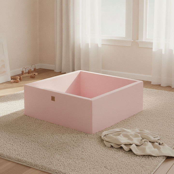 MeowBaby Powder Pink Square Cotton Ball Pit on a rug in a bright playroom