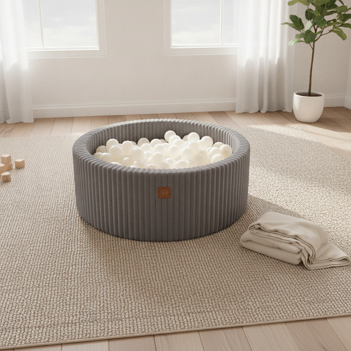 MeowBaby Jurassic Grey Churros round ball pit on a rug in a bright playroom