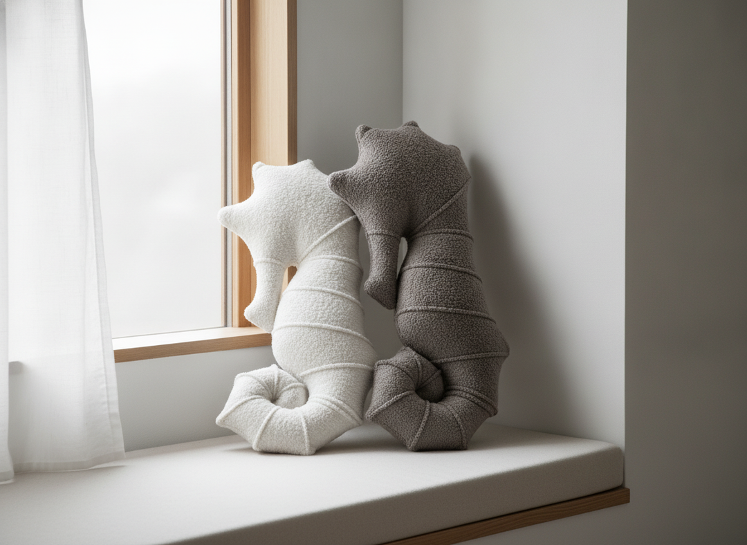 MeowBaby Seahorse Decorative Pillows in White and Charcoal Taupe together on a window seat