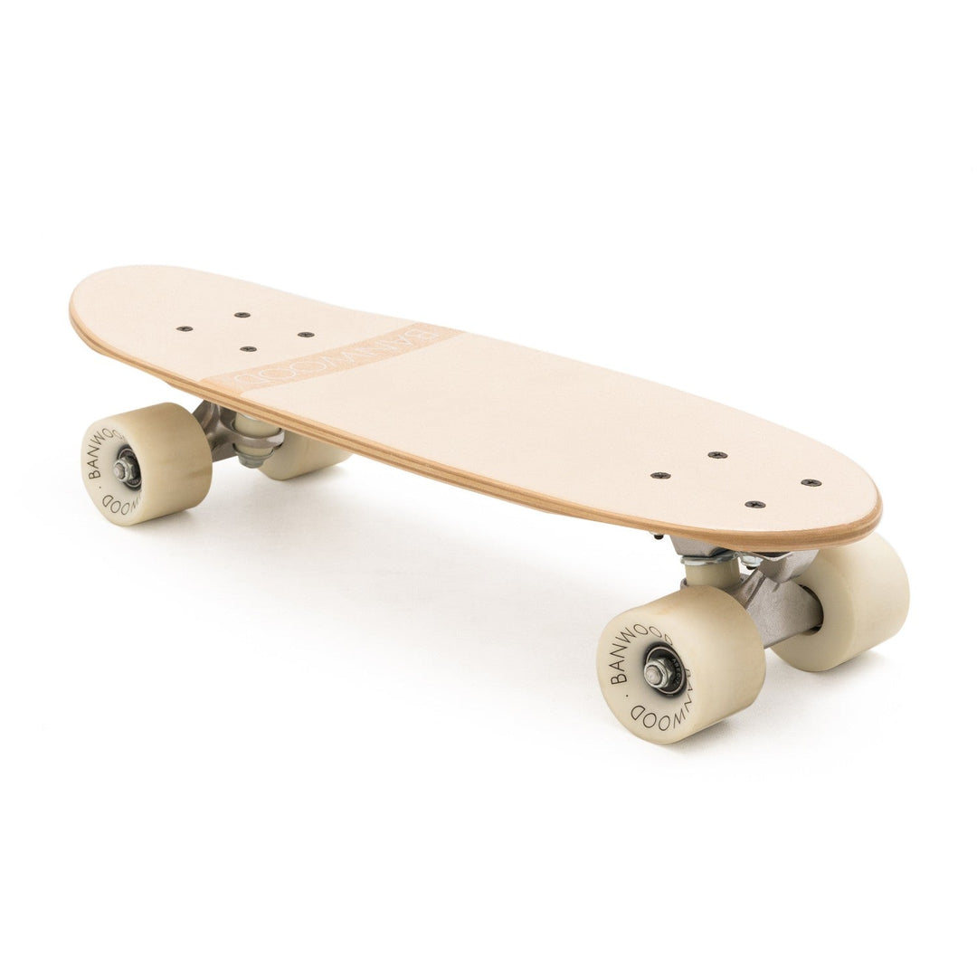 Three-quarter view of Banwood skateboard in cream with wheels and visible wood texture