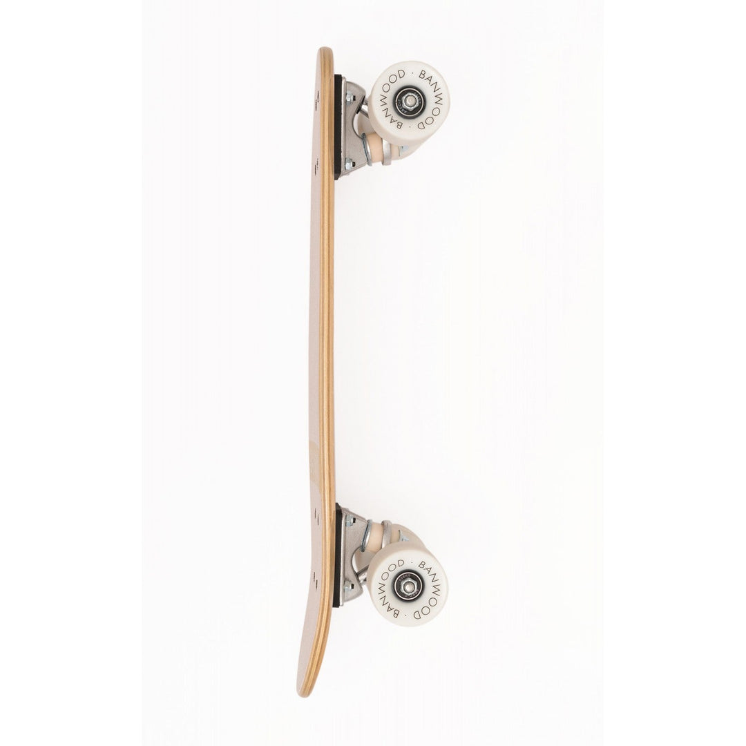 Skateboard side view with white rebounding wheels and metal truck bearing