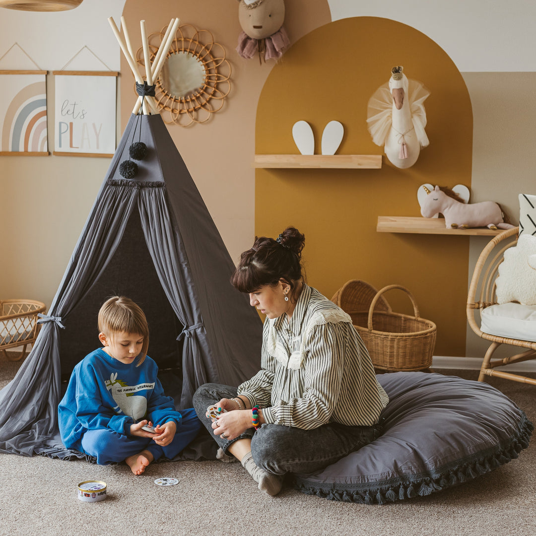 The MINICAMP grey floor cushion shown from above, plain cotton cover with tasselled edge trim