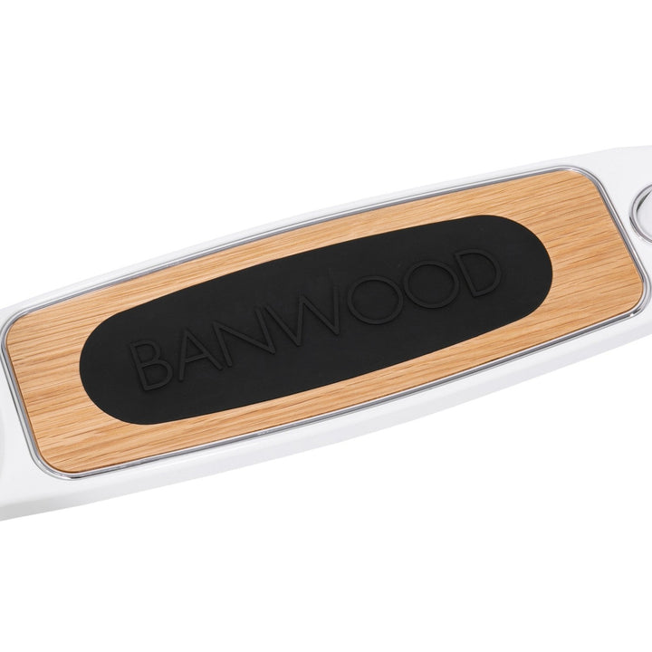 Scooter deck detail showing Banwood shield badge and natural wood finish